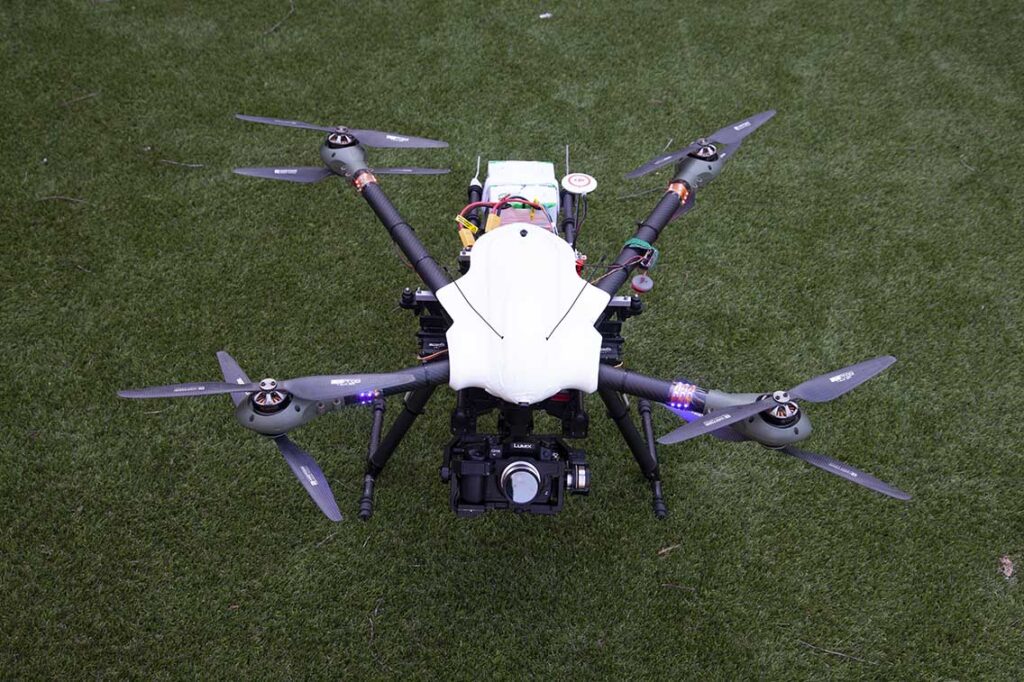 Octocopter drone sitting on grass