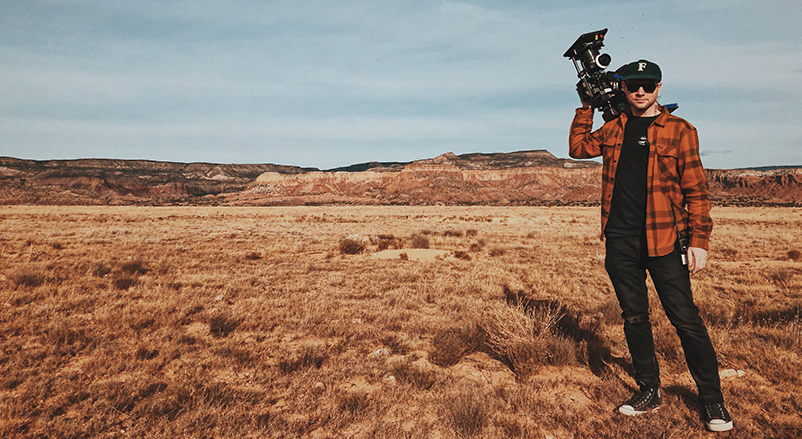 Man holding camera in desert